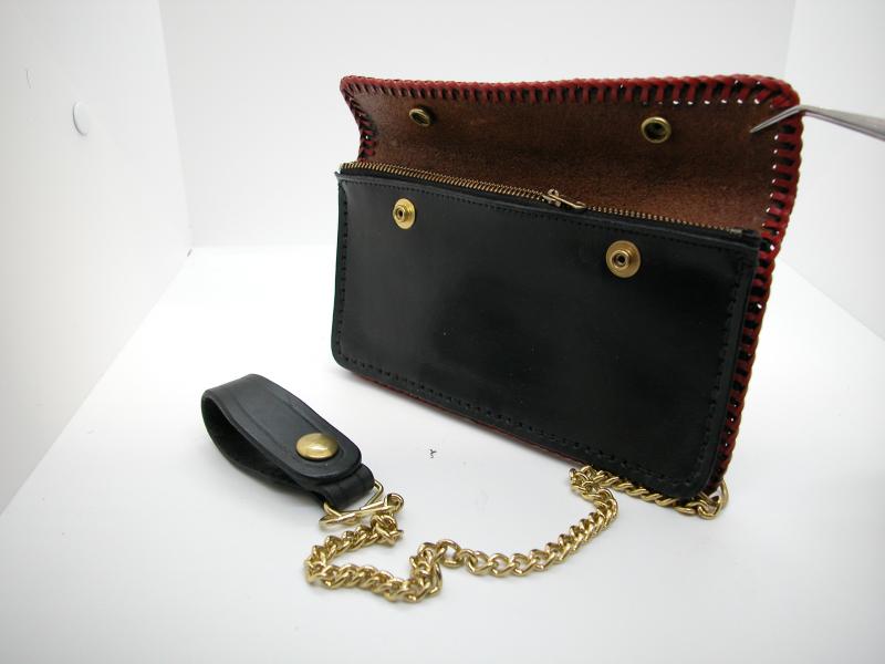 This Midnight Black Trucker Style Wallet Made With Red Leather Lacing comes With a Brass chain and leather Belt Loop Tether, Custom, Full Grain Leather, Hand tooled, Hand Made in the Okanagan, Oliver, B.C., Canada.